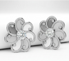 Halo des Fleurs laurel blossom earrings in 850 platinum with white moonstone center
Close-up of satin-finished laurel blossom earring with beveled petals and diamond pavé
Halo des Fleurs floral earring in platinum with diamond center and white sapphire accents
24K yellow gold laurel blossom earring with white moonstone center and diamond pavé